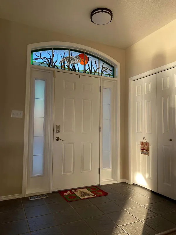 Photo of repainted door with stained glass in upper window